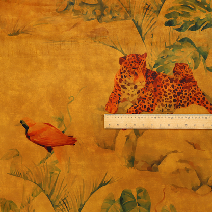 Fabric pattern featuring a warm orange and gold background with jungle wildlife, including leopards, tropical birds, large green leaves, and rocky terrain.
