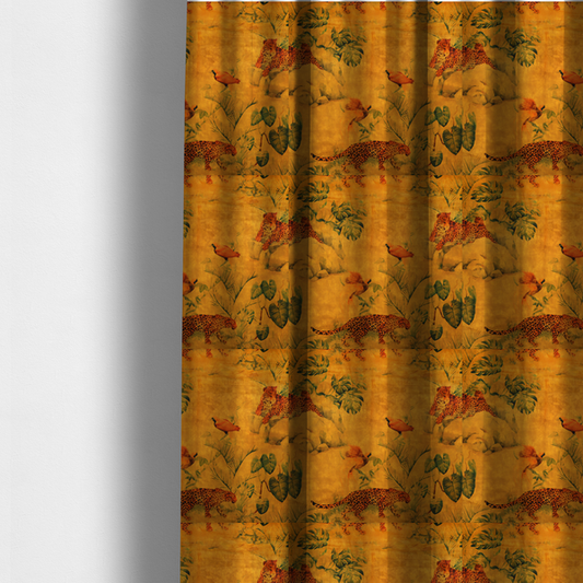 The fabric used to create these made-to-measure curtains is a warm orange and gold background with jungle wildlife, including leopards, tropical birds, large green leaves, and rocky terrain.