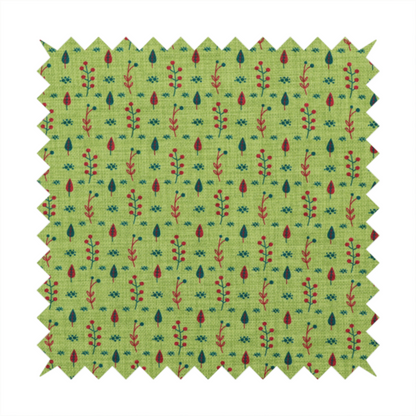 A green upholstery fabric featuring a ditsy folk-art pattern of small red berries, sprigs, and dark blue leaves.