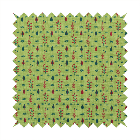 A green upholstery fabric featuring a ditsy folk-art pattern of small red berries, sprigs, and dark blue leaves.
