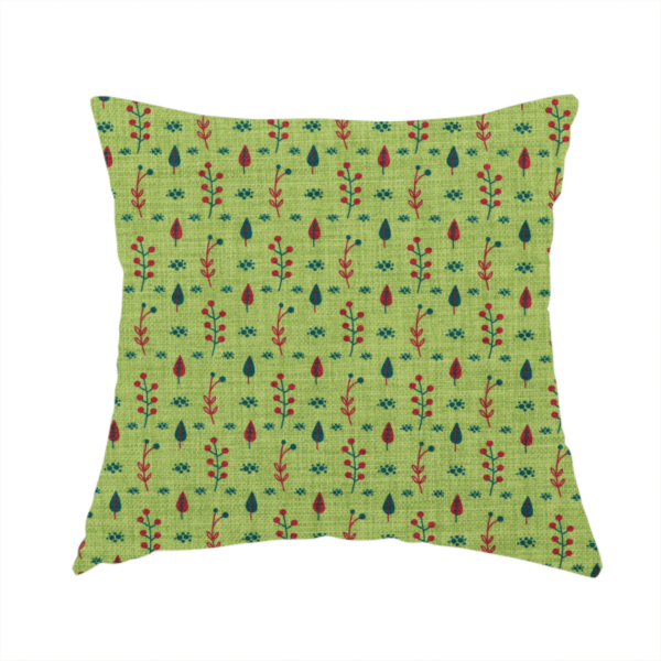 The fabric used to create this handmade cushion is a green upholstery fabric featuring a ditsy folk-art pattern of small red berries, sprigs, and dark blue leaves.