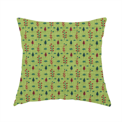 The fabric used to create this handmade cushion is a green upholstery fabric featuring a ditsy folk-art pattern of small red berries, sprigs, and dark blue leaves.