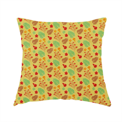 The fabric used to create this handmade cushion is a yellow upholstery fabric featuring a vibrant tropical pattern of red, green, and brown leaves and flowers.