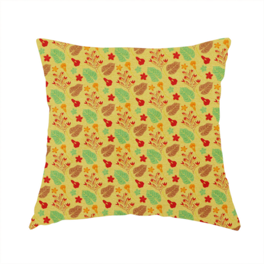 The fabric used to create this handmade cushion is a yellow upholstery fabric featuring a vibrant tropical pattern of red, green, and brown leaves and flowers.