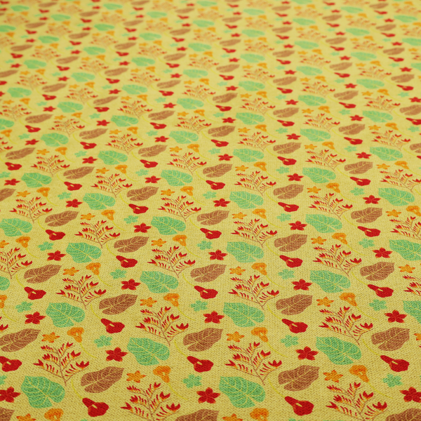 A yellow upholstery fabric featuring a vibrant tropical pattern of red, green, and brown leaves and flowers.