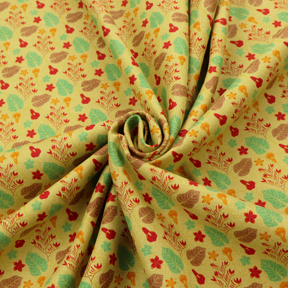 A yellow upholstery fabric featuring a vibrant tropical pattern of red, green, and brown leaves and flowers.