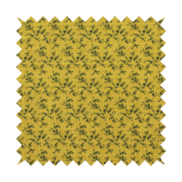 Mustard yellow fabric featuring a dense, repeating pattern of small dark green or black trailing vines with tiny leaves and a subtle woven texture.