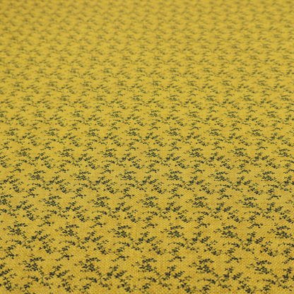 Mustard yellow fabric featuring a dense, repeating pattern of small dark green or black trailing vines with tiny leaves and a subtle woven texture.