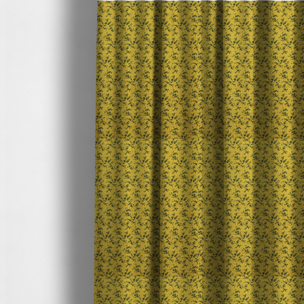 The fabric used to create these made-to-measure curtains is a mustard yellow fabric featuring a dense, repeating pattern of small dark green or black trailing vines with tiny leaves and a subtle woven texture.