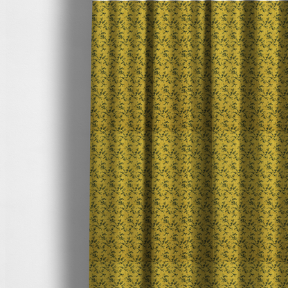The fabric used to create these made-to-measure curtains is a mustard yellow fabric featuring a dense, repeating pattern of small dark green or black trailing vines with tiny leaves and a subtle woven texture.