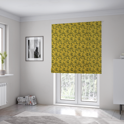 The fabric used to create these Roman blinds is a mustard yellow fabric featuring a dense, repeating pattern of small dark green or black trailing vines with tiny leaves and a subtle woven texture.