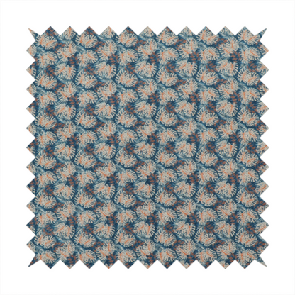 A dark blue and slate textured fabric featuring a dense, repeating mosaic pattern of small tropical leaves in shades of cream and rust orange.