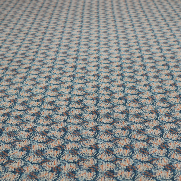 A dark blue and slate textured fabric featuring a dense, repeating mosaic pattern of small tropical leaves in shades of cream and rust orange.