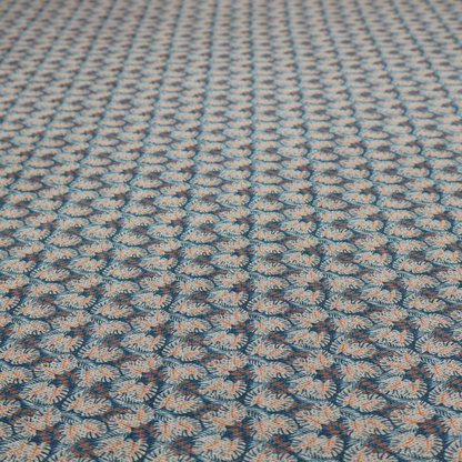 A dark blue and slate textured fabric featuring a dense, repeating mosaic pattern of small tropical leaves in shades of cream and rust orange.