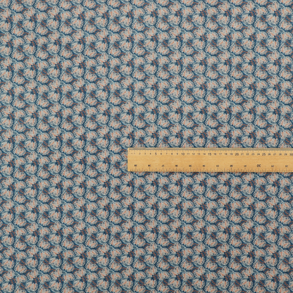 A dark blue and slate textured fabric featuring a dense, repeating mosaic pattern of small tropical leaves in shades of cream and rust orange.