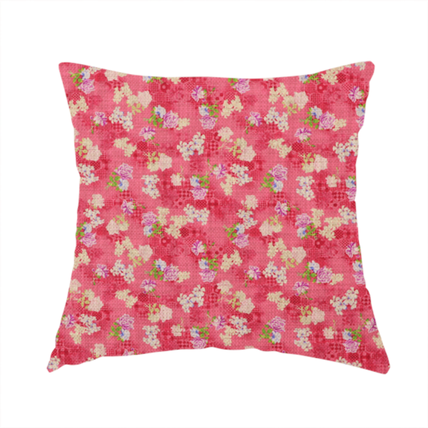 The fabric used to create this handmade cushion is a vibrant raspberry pink fabric featuring a dense, repeating pattern of small white, purple, and green floral clusters over a subtle checked texture.