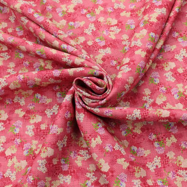 A vibrant raspberry pink fabric featuring a dense, repeating pattern of small white, purple, and green floral clusters over a subtle checked texture.
