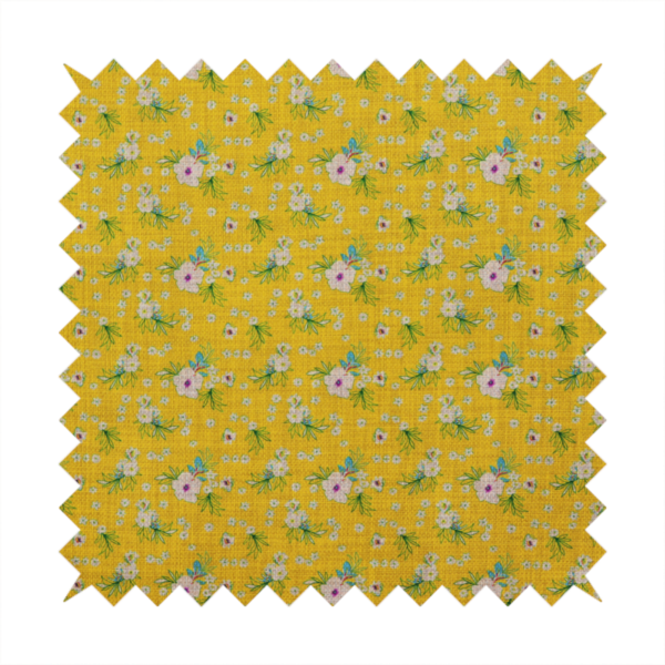 Textured mustard yellow fabric featuring a repeating micro floral pattern of small white and pink blossoms with green leaves and blue accents.