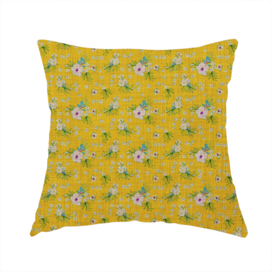 The fabric used to create this handmade cushion is a textured mustard yellow fabric featuring a repeating micro floral pattern of small white and pink blossoms with green leaves and blue accents.