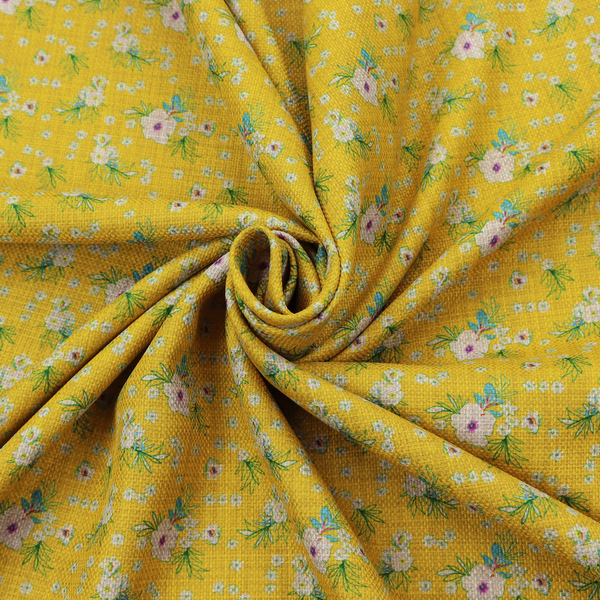Textured mustard yellow fabric featuring a repeating micro floral pattern of small white and pink blossoms with green leaves and blue accents.