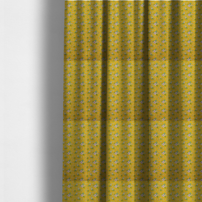 The fabric used to create these made-to-measure curtains is a textured mustard yellow fabric featuring a repeating micro floral pattern of small white and pink blossoms with green leaves and blue accents.