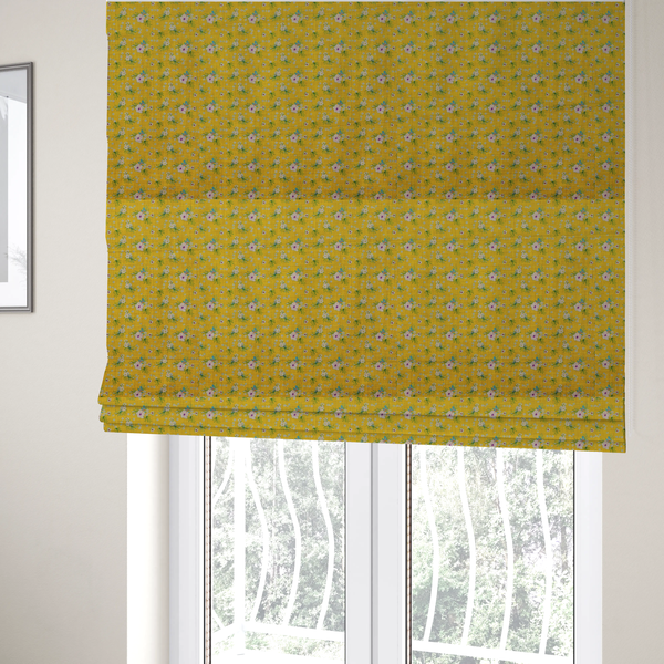 The fabric used to create these Roman blinds is a textured mustard yellow fabric featuring a repeating micro floral pattern of small white and pink blossoms with green leaves and blue accents.