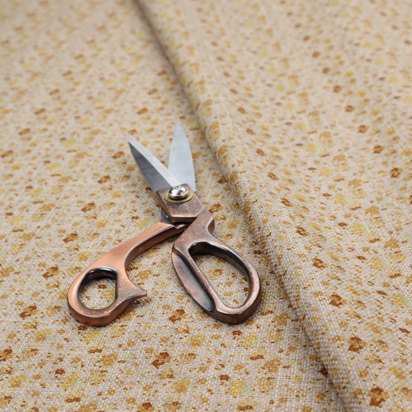 Textured light beige or cream fabric featuring a dense repeating pattern of tiny gold, yellow, and brown micro flowers.