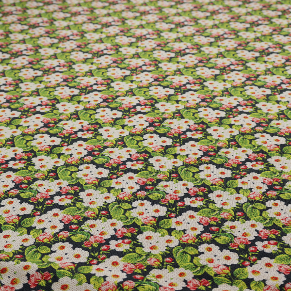 A dense vintage-style micro-floral print fabric featuring tiny white blossoms, pink buds, and green leaves set against a dark background.