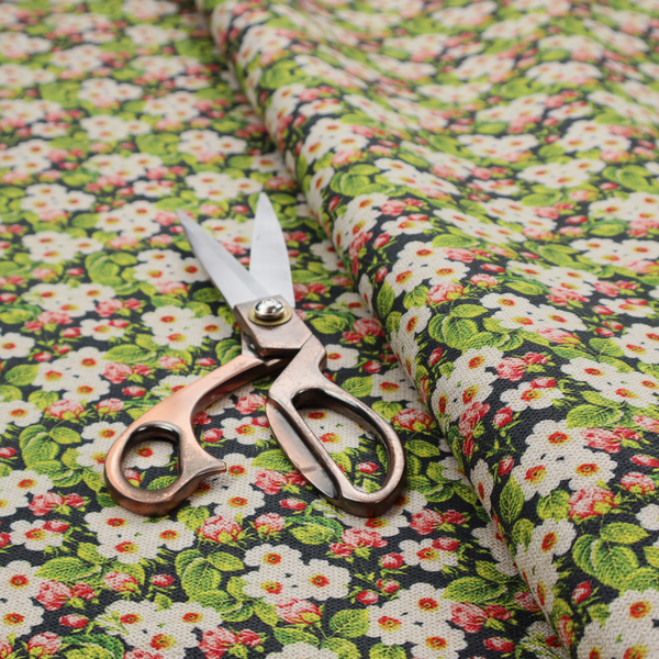 A dense vintage-style micro-floral print fabric featuring tiny white blossoms, pink buds, and green leaves set against a dark background.