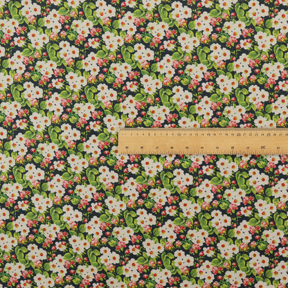 A dense vintage-style micro-floral print fabric featuring tiny white blossoms, pink buds, and green leaves set against a dark background.