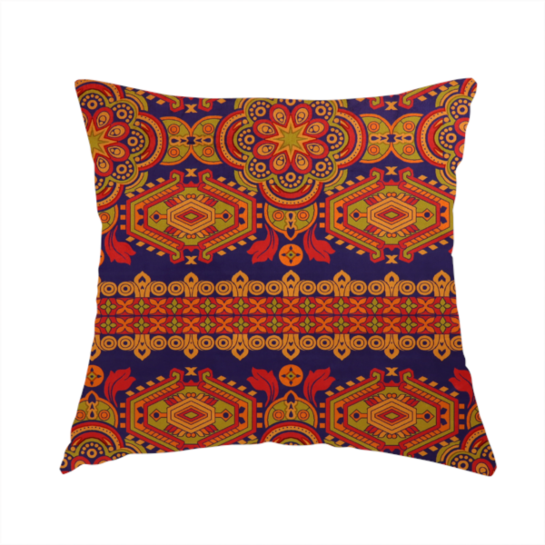 The fabric used to create this handmade cushion is a deep purple textile adorned with intricate, ornate patterns including large mandala medallions, geometric motifs, and a central horizontal decorative stripe in shades of red, orange, and olive green.