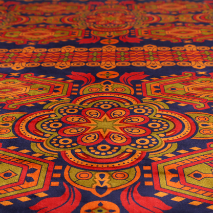 A deep purple textile adorned with intricate, ornate patterns including large mandala medallions, geometric motifs, and a central horizontal decorative stripe in shades of red, orange, and olive green.