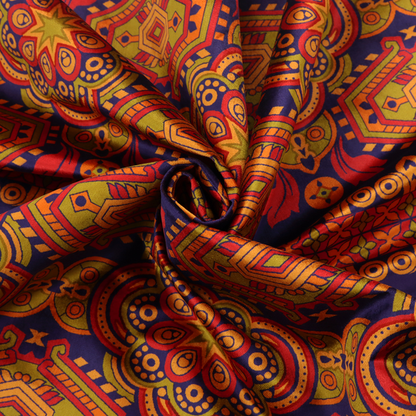 A deep purple textile adorned with intricate, ornate patterns including large mandala medallions, geometric motifs, and a central horizontal decorative stripe in shades of red, orange, and olive green.