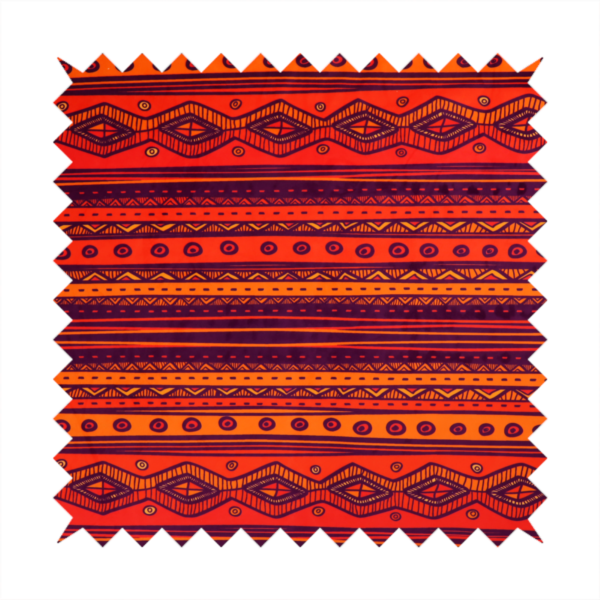 A vibrant orange and red fabric featuring a repeating tribal geometric and striped pattern.