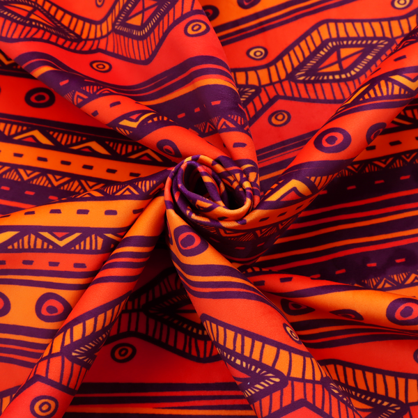 A vibrant orange and red fabric featuring a repeating tribal geometric and striped pattern.