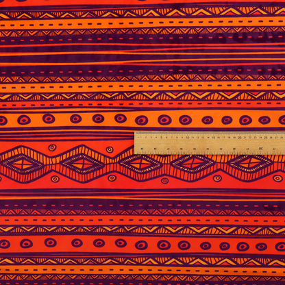 A vibrant orange and red fabric featuring a repeating tribal geometric and striped pattern.