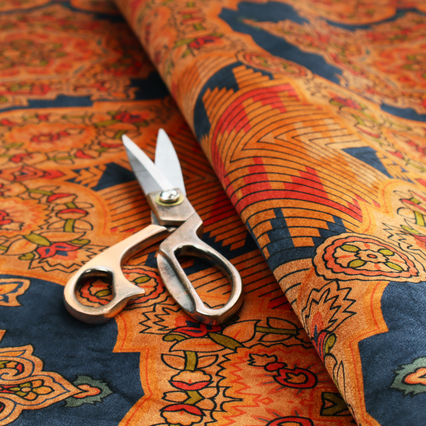 A large, diamond-shaped geometric centrepiece filled with fine diagonal lines and stair-step tribal or Aztec-inspired patterns in orange and dark blue.