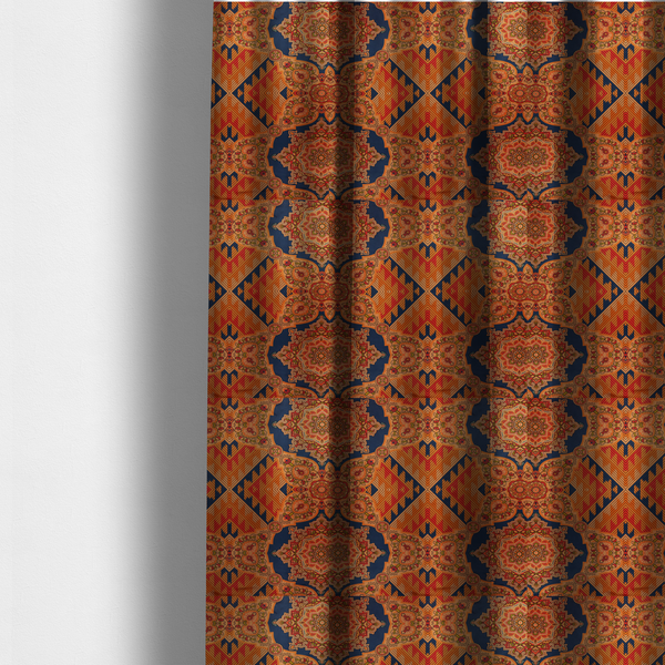 The fabric used to create these made-to-measure curtains is a large, diamond-shaped geometric centrepiece filled with fine diagonal lines and stair-step tribal or Aztec-inspired patterns in orange and dark blue.