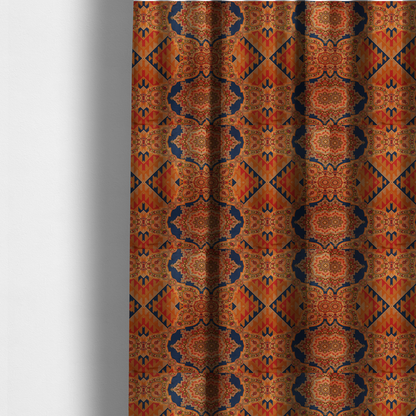 The fabric used to create these made-to-measure curtains is a large, diamond-shaped geometric centrepiece filled with fine diagonal lines and stair-step tribal or Aztec-inspired patterns in orange and dark blue.