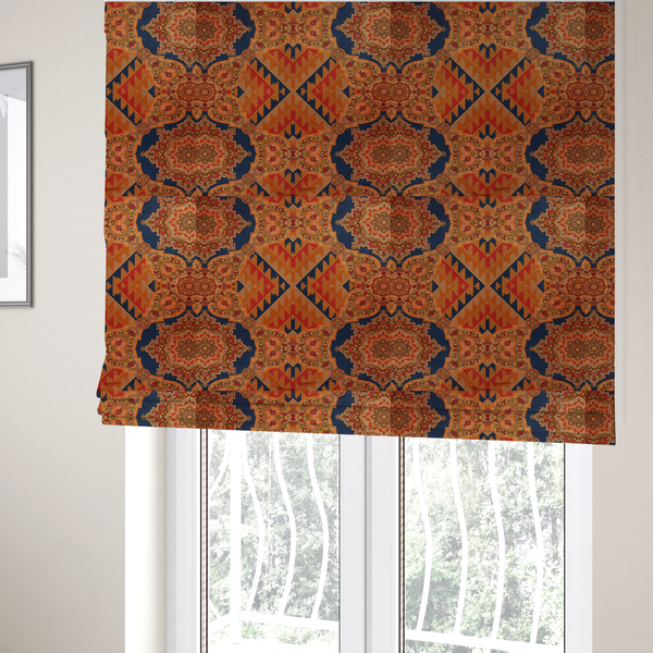 The fabric used to create these Roman blinds is a large, diamond-shaped geometric centrepiece filled with fine diagonal lines and stair-step tribal or Aztec-inspired patterns in orange and dark blue.