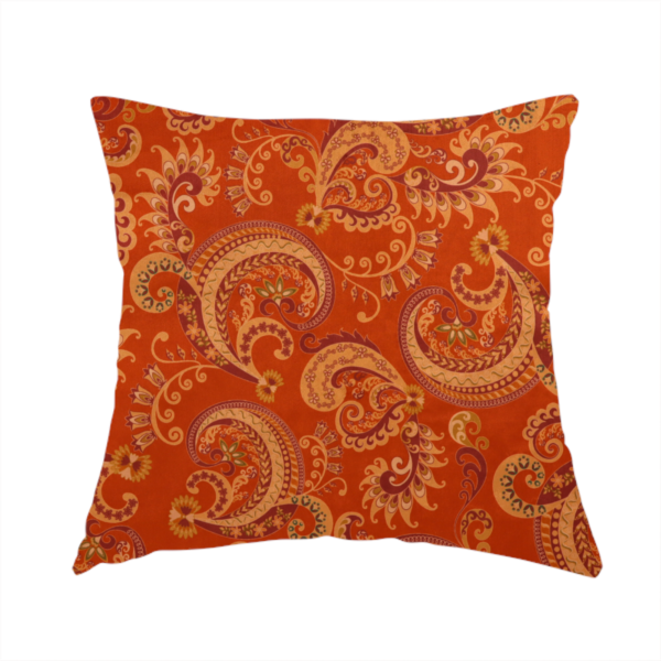 The fabric used to create this handmade cushion is an elaborate, repeating paisley and baroque scroll design filled with swirling vines, teardrop shapes, and floral flourishes.