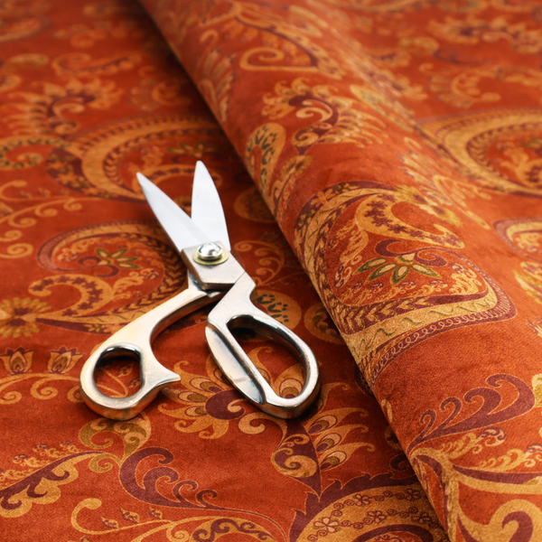 An elaborate, repeating paisley and baroque scroll design filled with swirling vines, teardrop shapes, and floral flourishes.