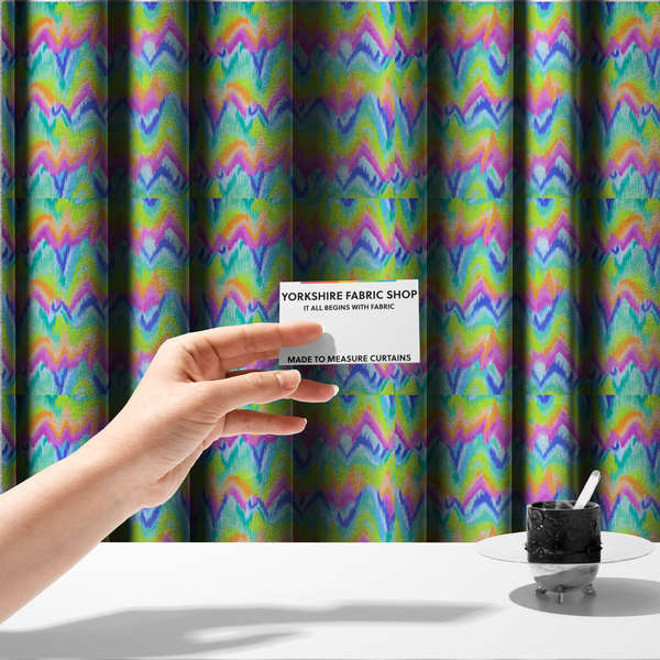 The fabric used to create these made-to-measure curtains is a high-energy neon mix of electric pink, bright lime green, vivid orange, turquoise, light blue, and deep purple.