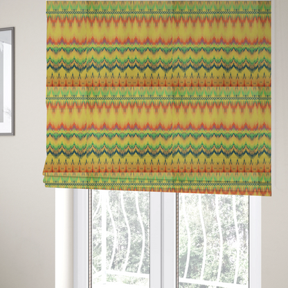 The fabric used to create these Roman blinds has horizontal bands of intricate, jagged zig-zags, flame-like vertical gradations, and a central diamond-patterned border stripe that mimic traditional ikat weaving.