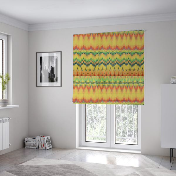 The fabric used to create these Roman blinds has horizontal bands of intricate, jagged zig-zags, flame-like vertical gradations, and a central diamond-patterned border stripe that mimic traditional ikat weaving.