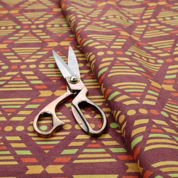 The image features a structured, geometric textile pattern with an Aztec-inspired aesthetic and repeated diamond motifs.