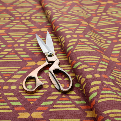 The image features a structured, geometric textile pattern with an Aztec-inspired aesthetic and repeated diamond motifs.