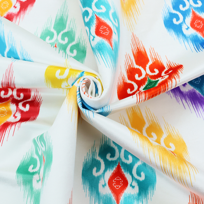 The image features a colourful, patterned textile with an ikat-style design and repeating diamond motifs.