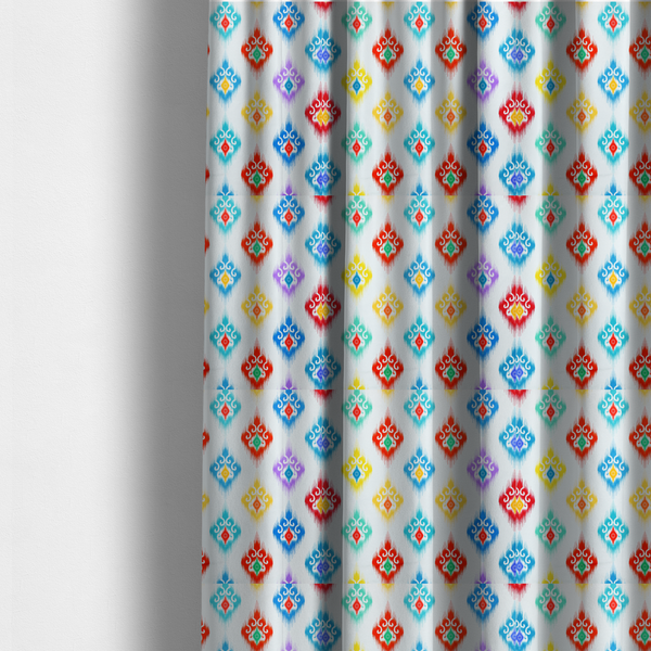 The fabric used to create these made-to-measure curtains is a colourful, patterned textile with an ikat-style design and repeating diamond motifs.