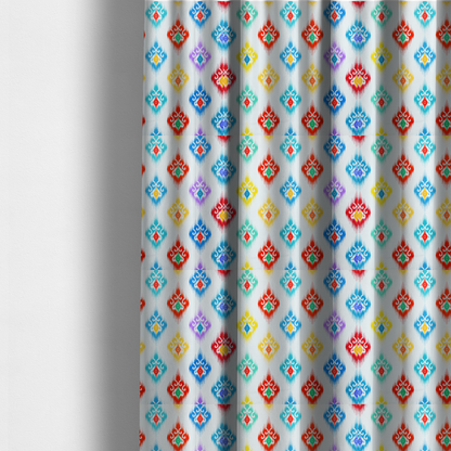 The fabric used to create these made-to-measure curtains is a colourful, patterned textile with an ikat-style design and repeating diamond motifs.